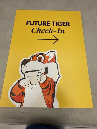 An image of a yellow "Future Tiger Check-In" sign.